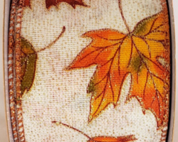 ORNG LEAVES IVY LIN-2.5" WR This bow is for a fall collection. Streamers will be solid ribbon in the colors of orange, rust, olive green and ivory. If available, a coordinating text streamer for the desired occasion could be added.